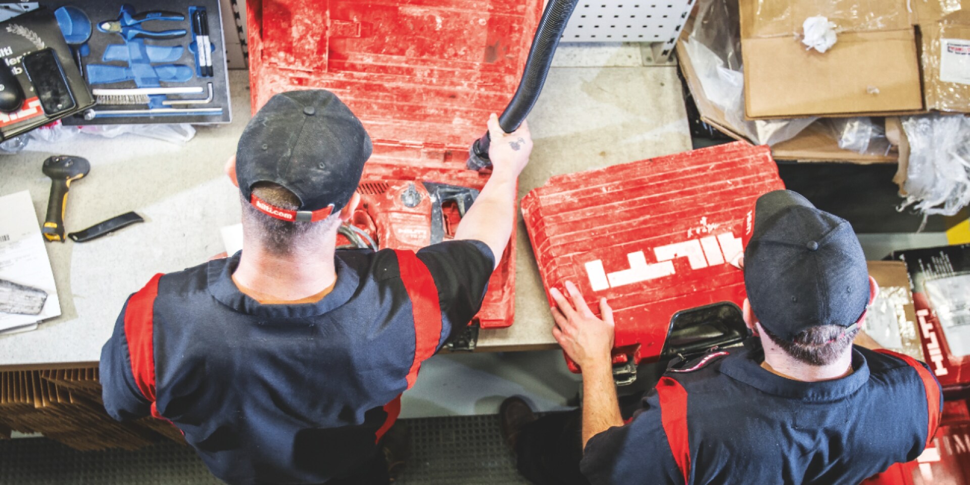 Two Hilti employees repairing a rotary hammer