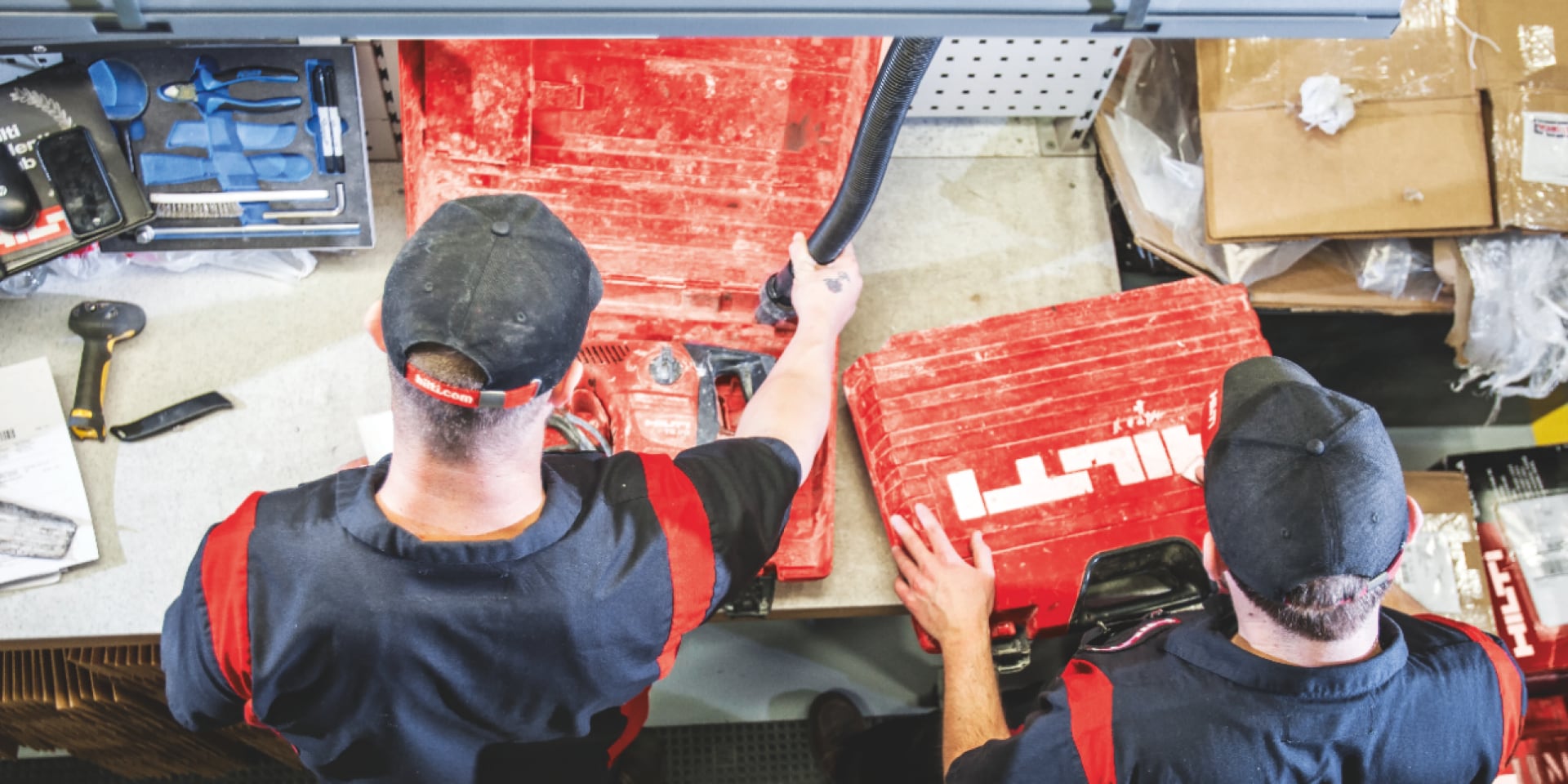 Two Hilti employees repairing a rotary hammer